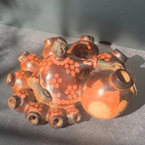 Chulucana woman sitting among pots